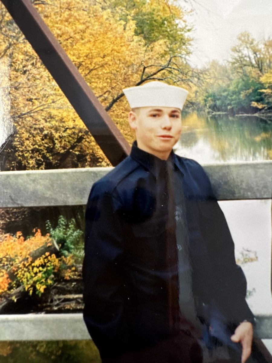 This photo was taken by Marshamn’s mother, Carole Marshman after he finished his training at The Naval Training Command Great Lakes. It shows Dustin on a bridge wearing the sailors hat that is a part of the Navy Uniform.