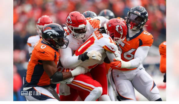 Chiefs running back Isiah Pacheco tries to push his way through the Broncos defense.