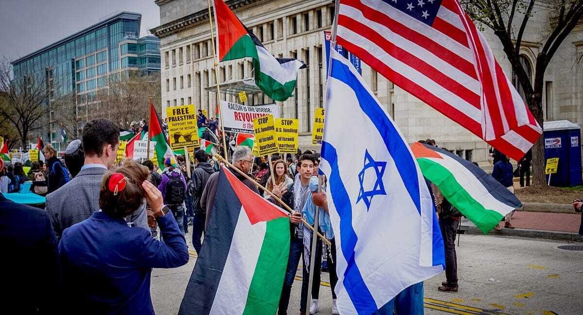 Protesters in favor of Israel and Palestine stand waving their flags in the street. These protesters are arguing because they stand on different sides. Protests have erupted across the world in support of Israel and support of Palestine. More casualties in the region are reported every day.