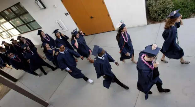This image is of the senior class of 2016. It was taken during the Graduation Parade. In this parade, the seniors walk through the elementary, middle, and high school hallways before walking out the front gate. This happens on their last day of school after they have completed all of their finals.