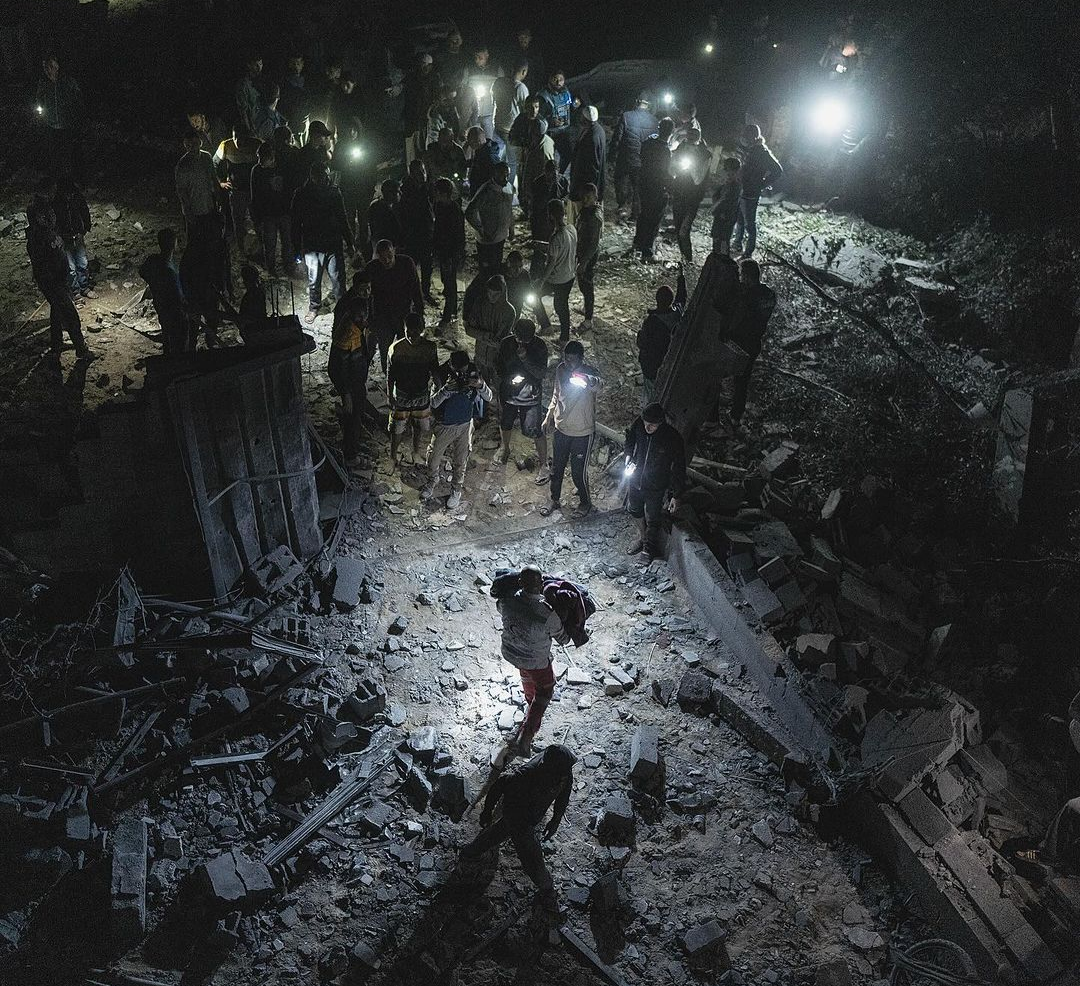 Israeli warplanes bombed a house in Dair al-balah city, middle of Gaza Strip.

People were sleeping, as the house was full of displaced people from Gaza City and the northern areas. 

At least 14 people got killed and dozens are injured. - Motaz Azaiza on his Instagram page.
