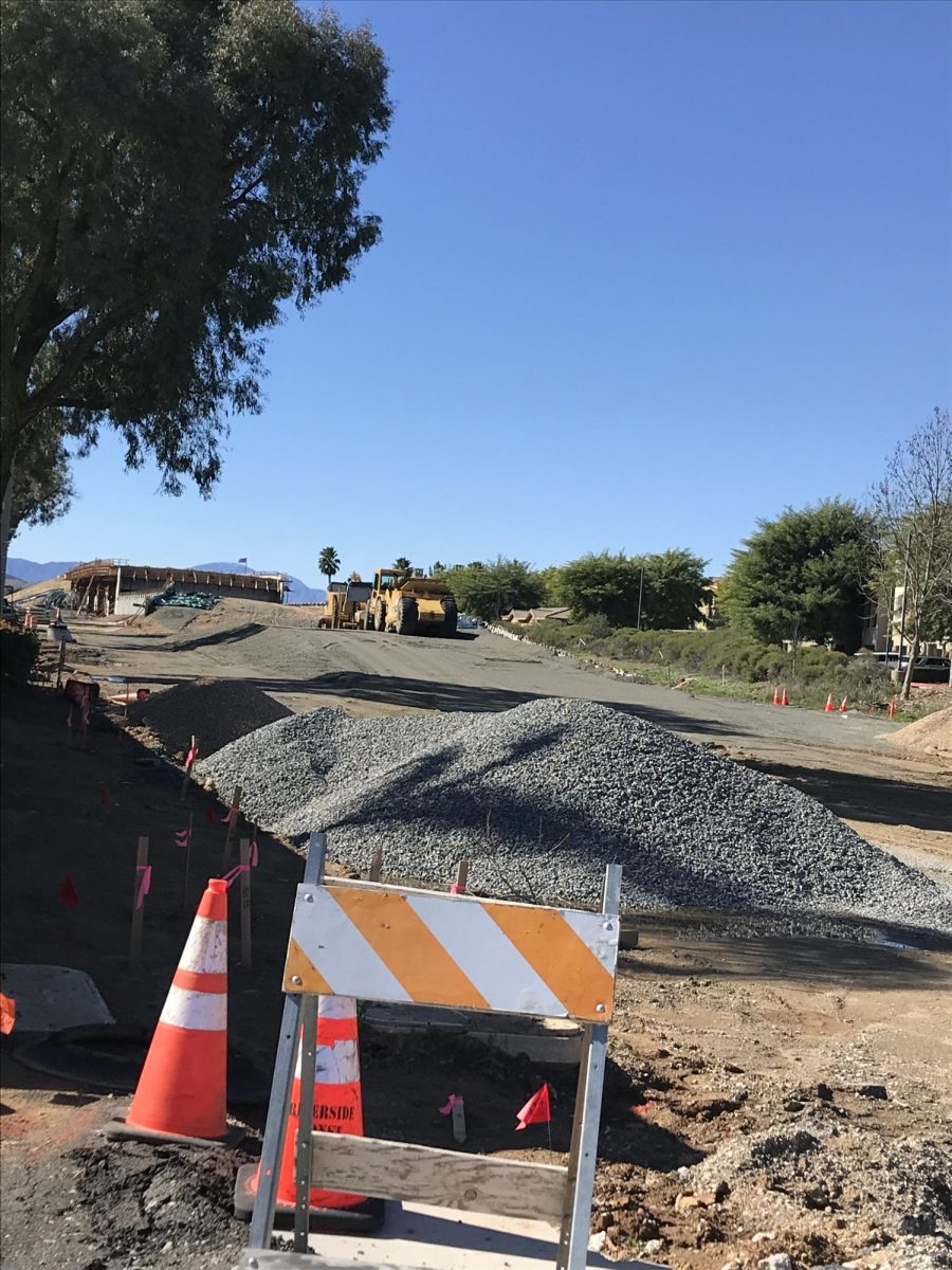 The Holland Road Overpass from Hanover Lane.  There are two construction vehicles on the site. 