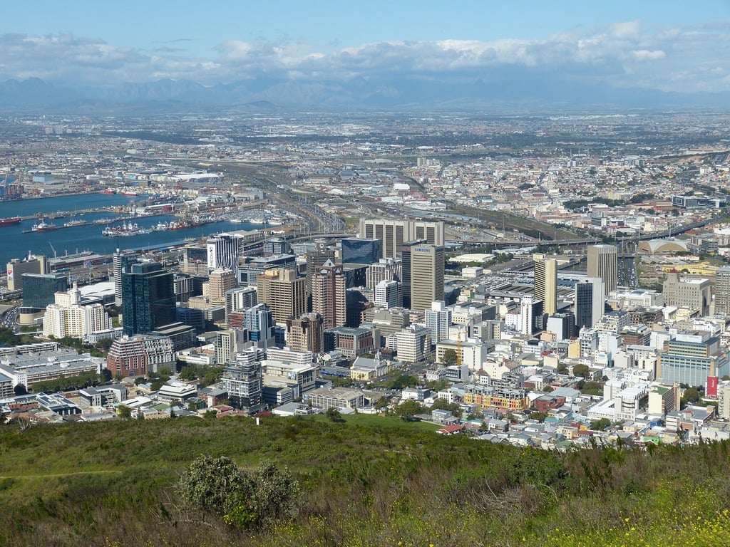 Cape Town South Africa distant view building. A view of a city from the top of the hill. Architecture stock photograph: A city is seen from a hill overlooking the ocean / A view of a city from the top of a hill.
