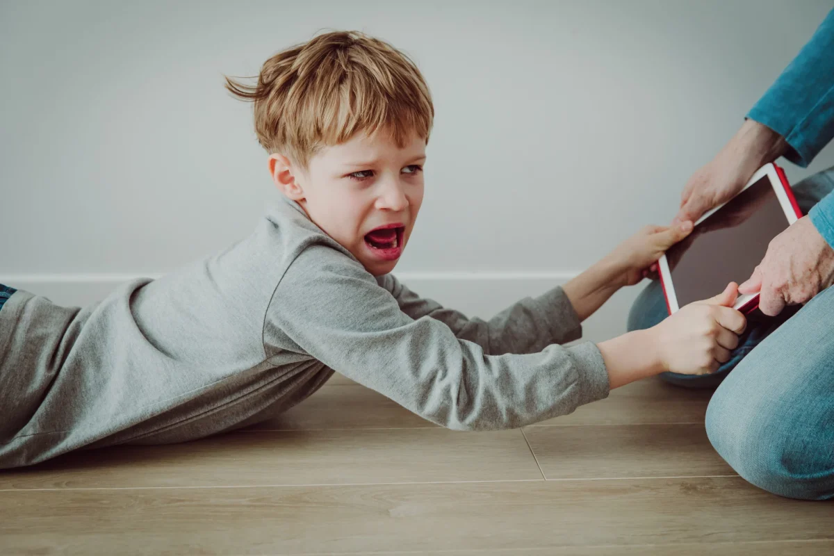 iPad kid screaming when their device is being taken away; no interest in toys