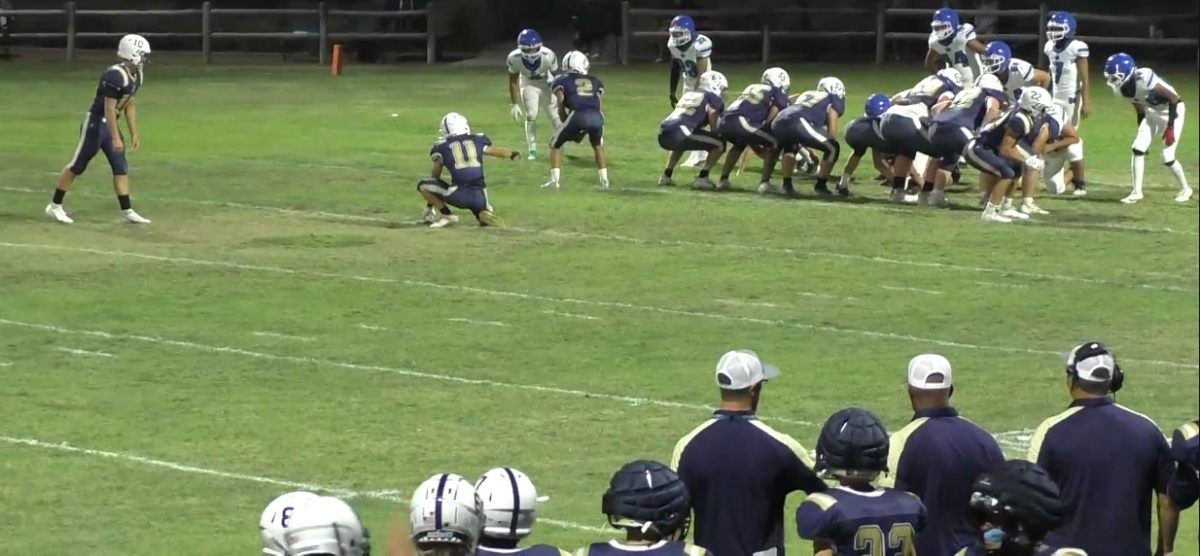 Quarterback Daniel Marlow preparing to kick field goal