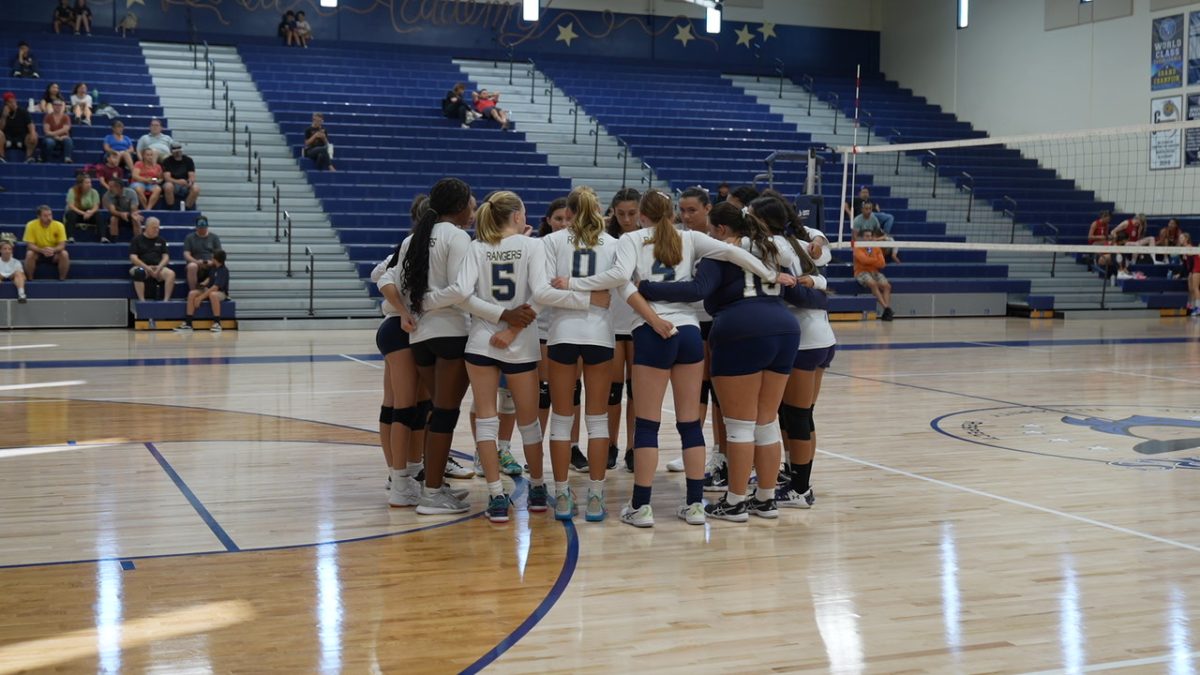 Santa Rosa Academy’s JV Girls Volleyball Team comes together in a huddle before the game to motivate one another to prepare to beat Temecula Prep.