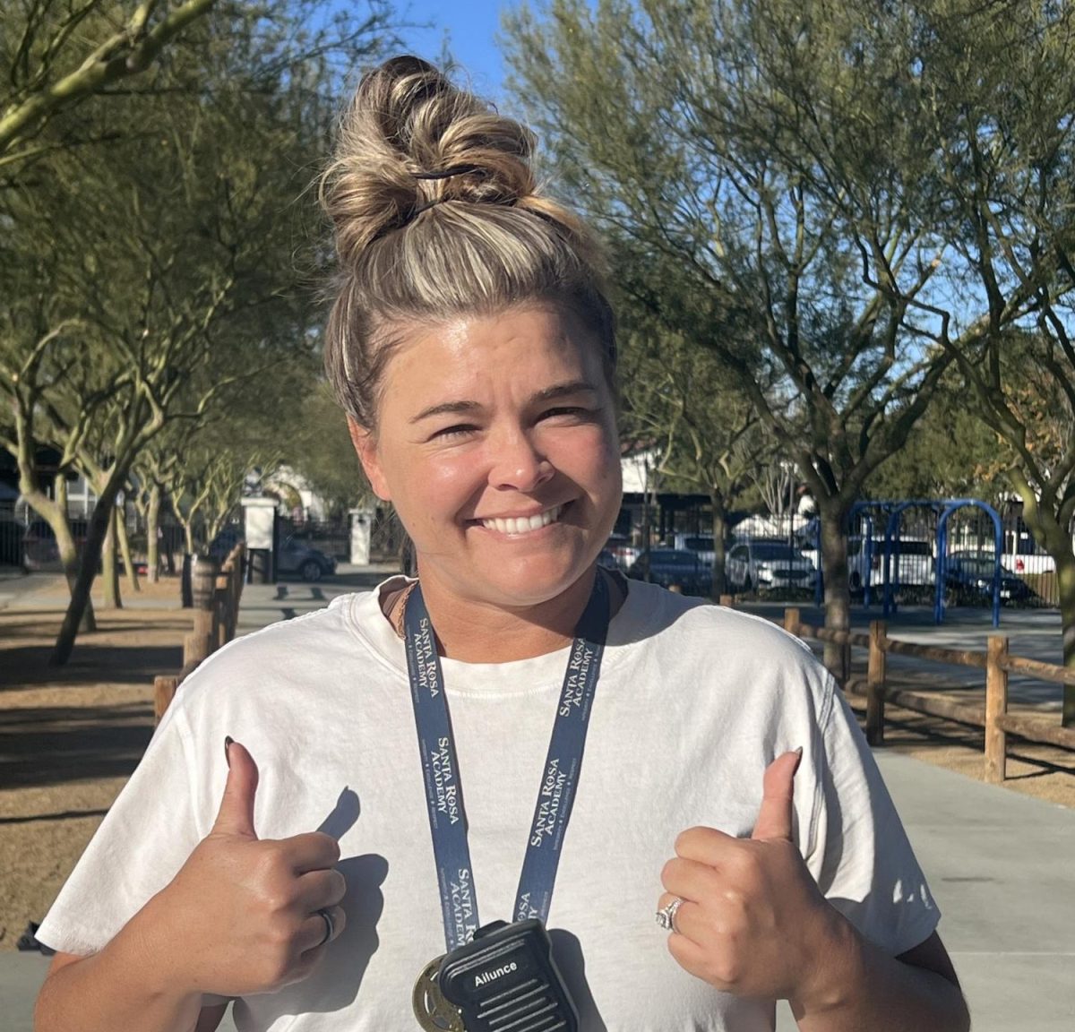 Coach Wood posing for a picture just before practice and celebrating last night's win. After teaching middle school P.E, she joined high school out on the field for practice.