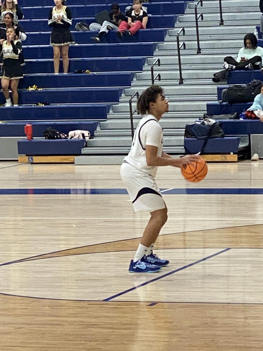 #11, Cory Moore is lined up at the free throw line and preparing to take his shot.
