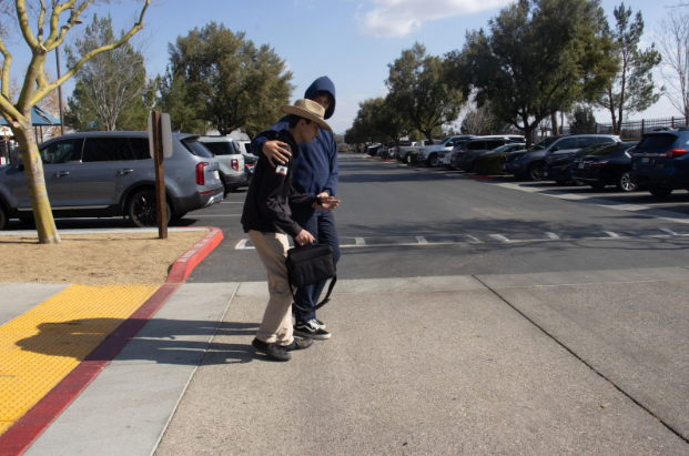 Two Santa Rosa Academy students representing how someone can help another member of the community. Kindness can go a long way and in this case it can help someone cross the street.