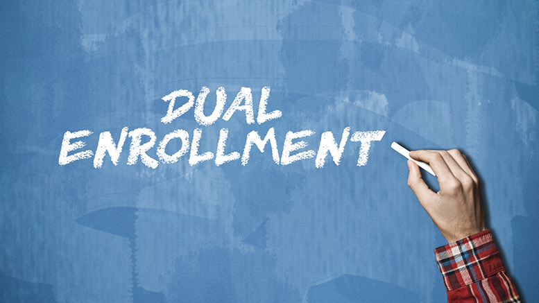 The image shows a man writing in chalk: "Dual Enrollment".